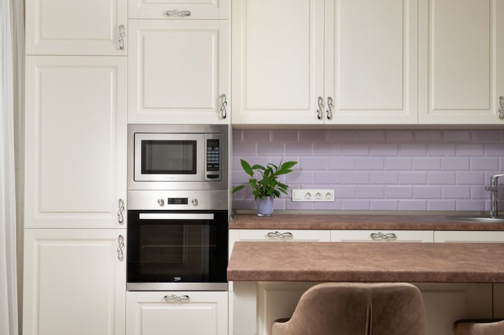 Stylish kitchen interior featuring cabinetry, built-in microwave, and elegant decor.